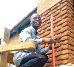 Bricklaying trainee with a trowel and level